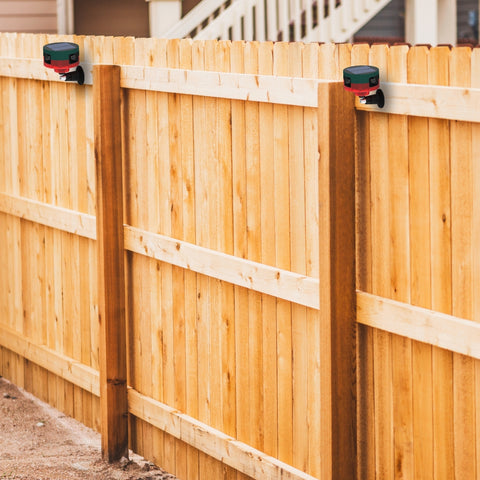 motion detector strobe light installed on a fence